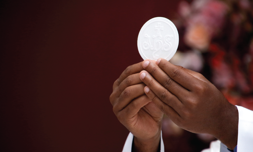 Priest elevating the Eucharist