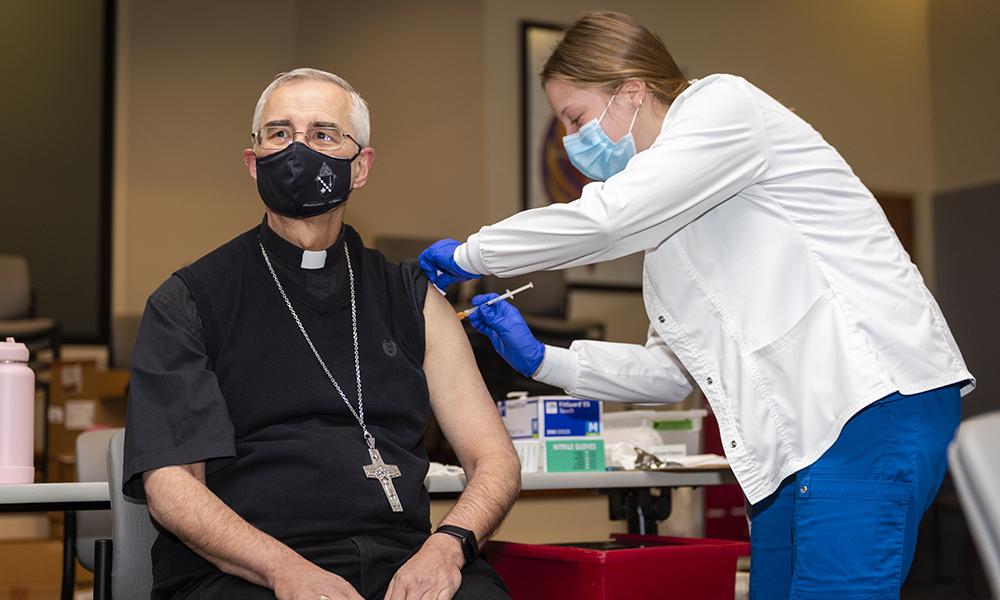 Bishop Raica receiving Covid-19 vaccination